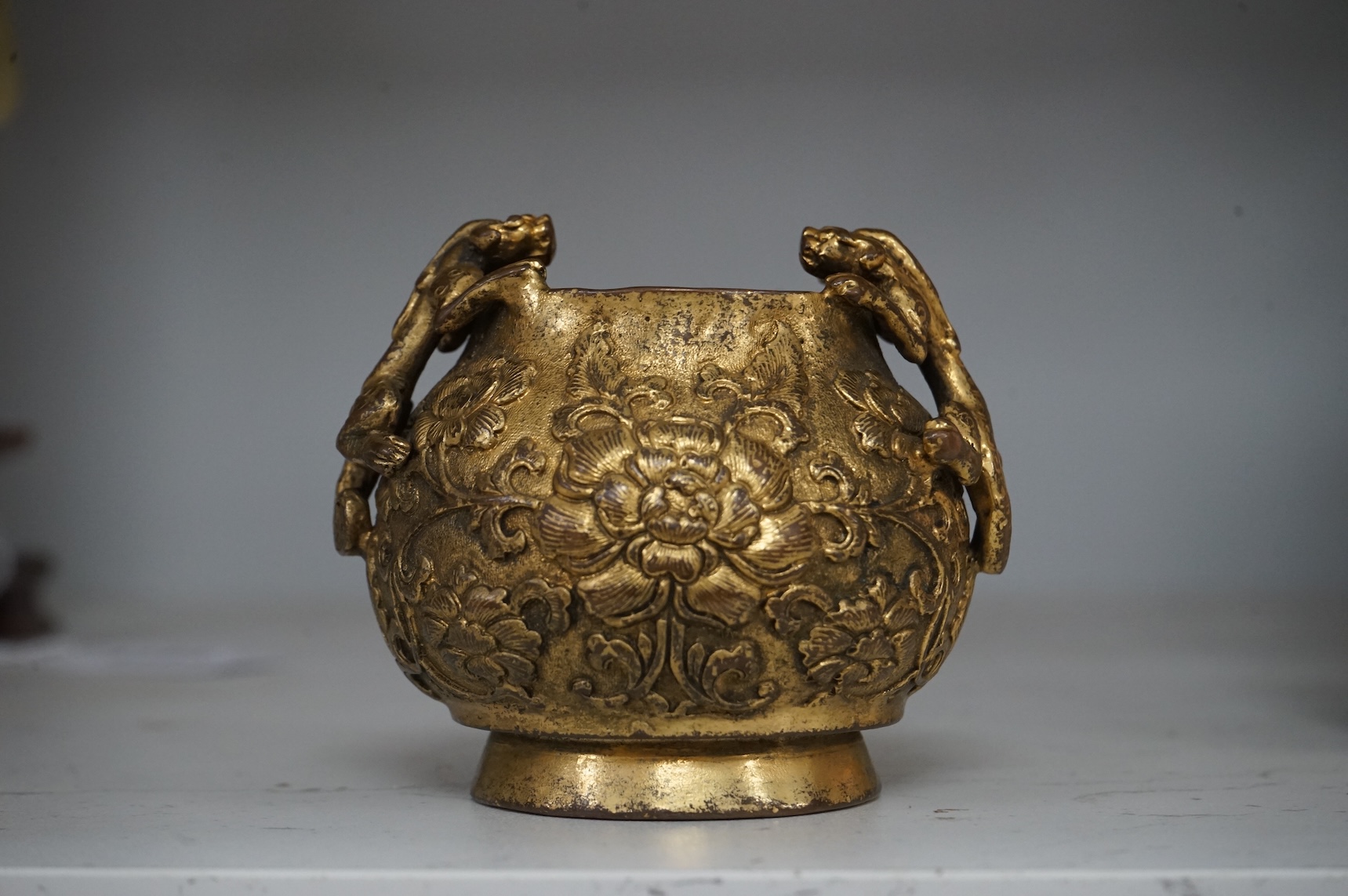 A Chinese gilt bronze vase decorated with applied lion dogs, 7.5cm high